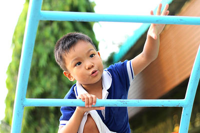 Cute boy looking away while playing in playground