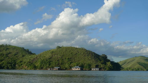 Scenic view of lake by trees against sky