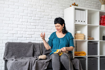 Woman sitting on sofa