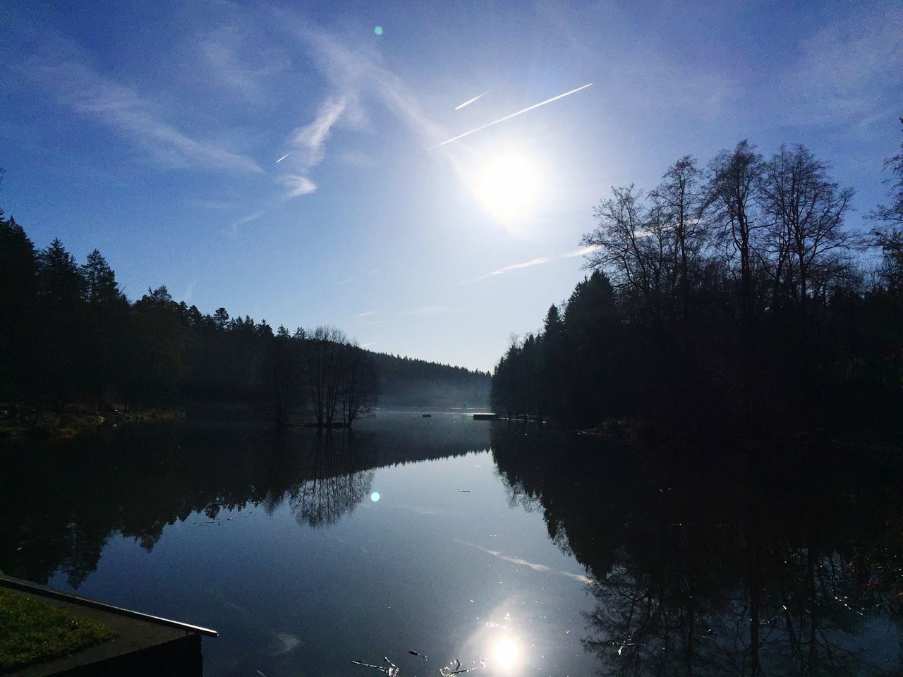 reflection, water, tree, tranquility, lake, tranquil scene, scenics, sky, beauty in nature, nature, waterfront, idyllic, standing water, silhouette, river, blue, outdoors, calm, sunlight, no people