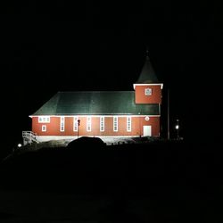 Illuminated building against sky at night