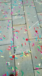 High angle view of multi colored paper on street