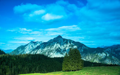 Scenic view of mountains against blue sky