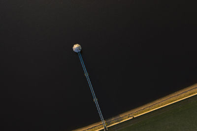 Low angle view of illuminated street light against sky