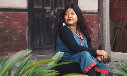 Portrait of woman sitting outdoors