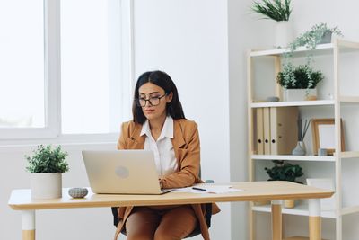 Young woman using laptop at home