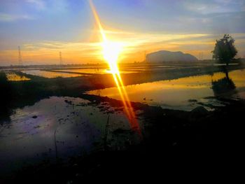 Scenic view of lake against sky during sunset