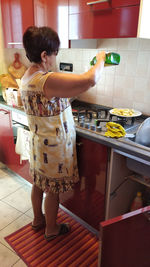 Full length of woman standing at home