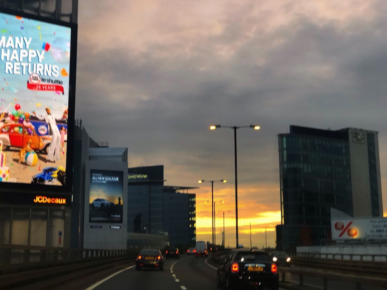 TRAFFIC ON ROAD IN CITY AT DUSK