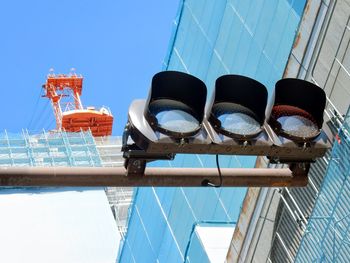 Low angle view of traffic lights against building