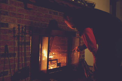 Man by fireplace