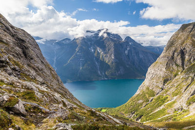 Idyllic shot of lake and mountains against sky