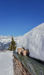 Scenic view of snowcapped mountains against clear blue sky