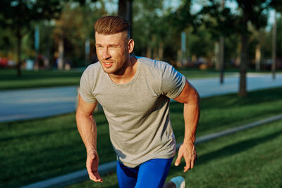 Portrait of young man exercising in park