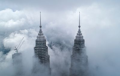 Drone shot of petronas towers in foggy weather