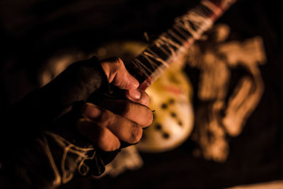 Close-up of hand holding guitar