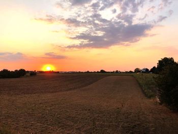 Scenic view of field against sky during sunset