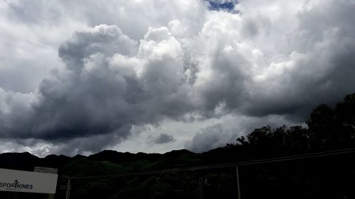 Scenic view of storm clouds over mountains