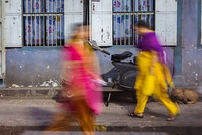 Blurred motion of people walking in city