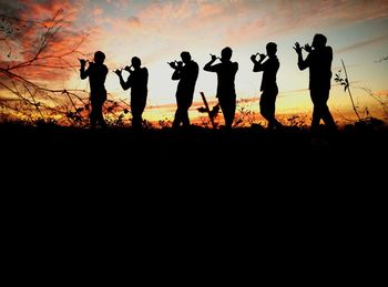Silhouette people at sunset