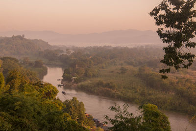 Scenic view of river against sky during sunset