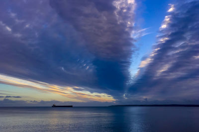 Scenic view of sea against dramatic sky