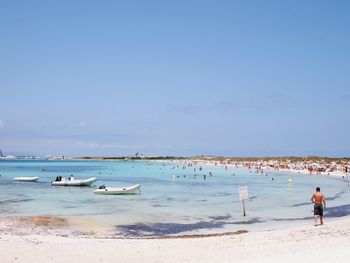 Scenic view of beach against blue sky