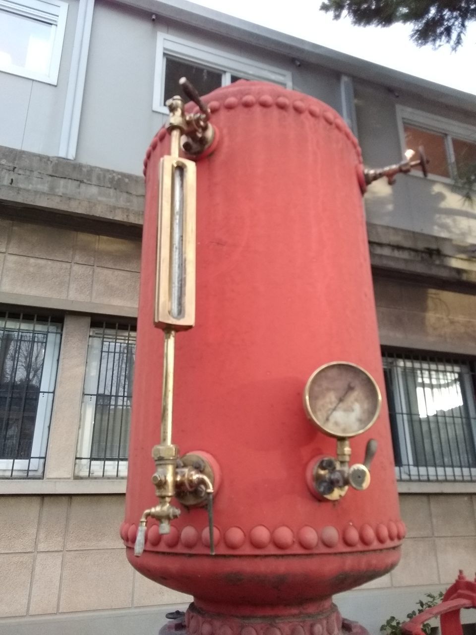 LOW ANGLE VIEW OF RED HANGING ON BUILDING