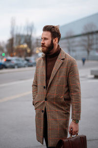 Portrait of young man standing on street