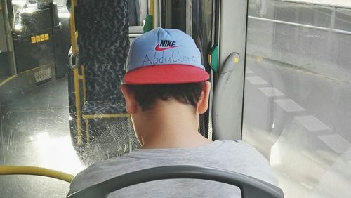 Rear view of senior woman in bus