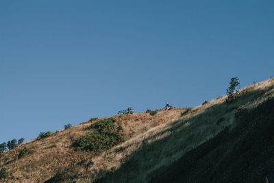 Low angle view of mountain against clear blue sky