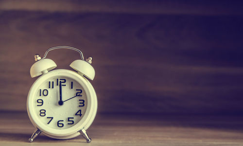 Close-up of alarm clock on table