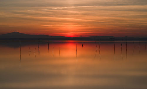 Scenic view of lake against romantic sky at sunset