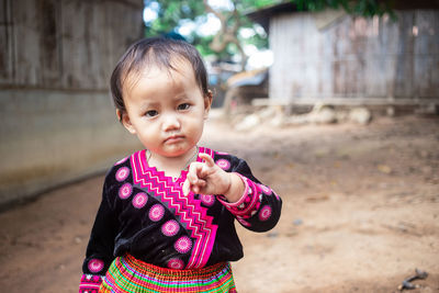 Portrait of cute girl standing outdoors