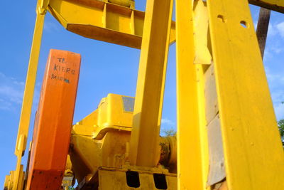 Low angle view of yellow construction site against sky