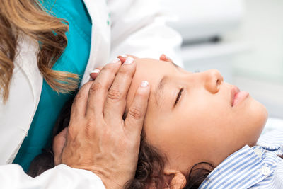 Female doctor giving massage to boy