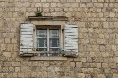 Low angle view of window on wall of building