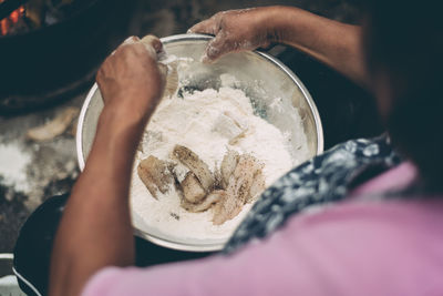 Midsection of woman preparing food in kitchen