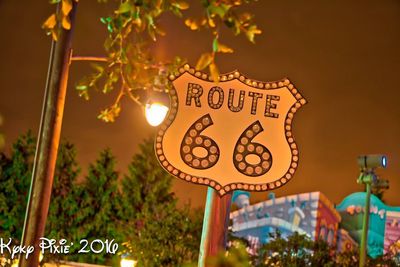 Low angle view of sign board against sky