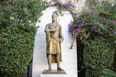 Statue of buddha against plants