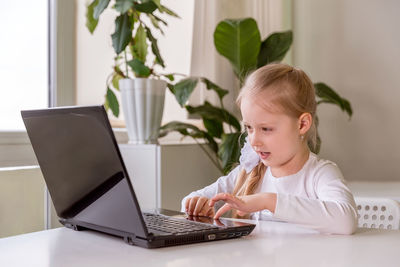 Girl sitting on table at home