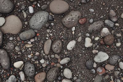 Full frame shot of pebbles on sand