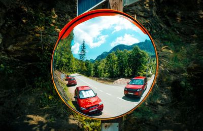 Red cars in traffic mirror