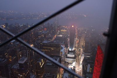 High angle view of illuminated city buildings against sky