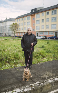 Senior woman going walkies with her yorkshire terrier