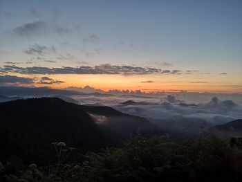 Scenic view of silhouette mountains against sky during sunset