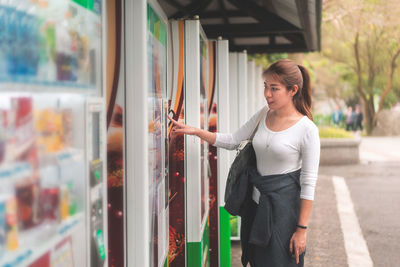 Woman using vending machine