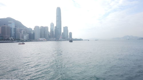 Panoramic view of sea and buildings against sky