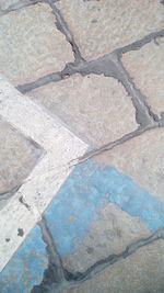High angle view of paving stones on footpath