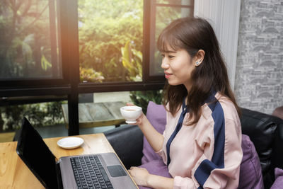 Young woman using laptop at office